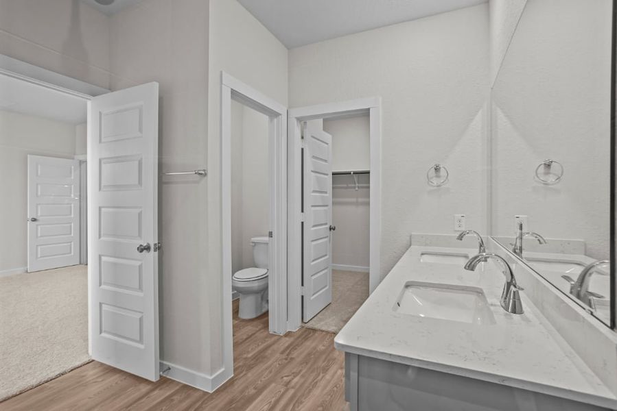 A bathroom with a sink toilet and a shower. A bathroom with a sink toilet and a shower.