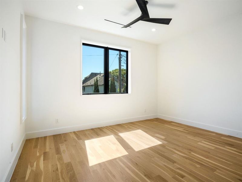 Unfurnished room featuring light wood finished floors, ceiling fan, and recessed lighting