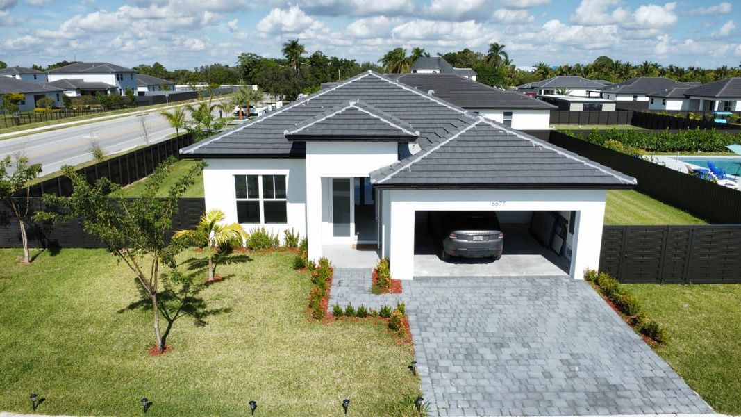 Front exterior of a new home in , Homestead, FL, highlighting curb appeal (Image 1). Front exterior of a new home in , Homestead, FL, highlighting curb appeal (Image 1).