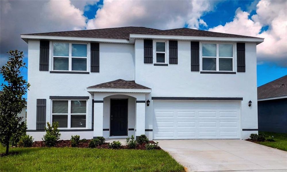 Front exterior of a new home in Oakfield Lakes, Parrish, FL, highlighting curb appeal (Image 1).