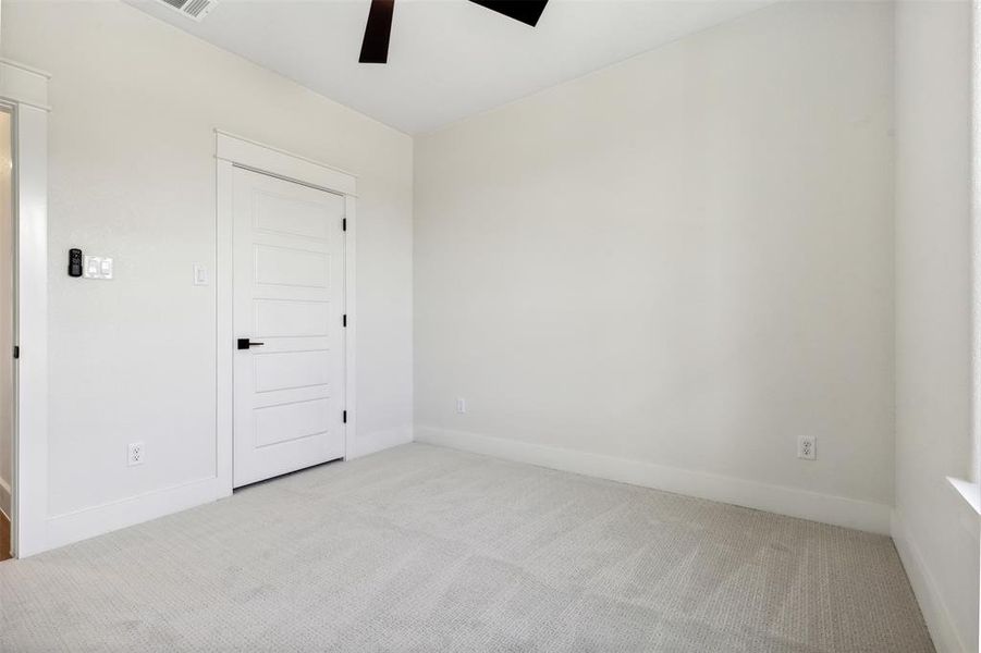 Unfurnished room with ceiling fan and light carpet