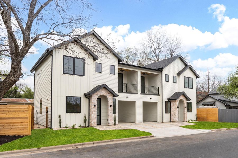 View of front facade with driveway, a balcony, an attached garage, a ceiling fan, and board and batten siding