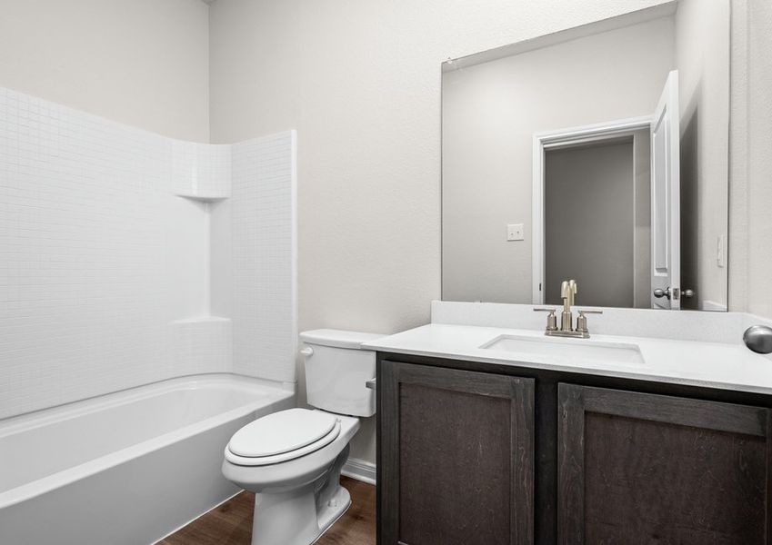 The secondary bathroom has a spacious vanity and shower-tub combo. The secondary bathroom has a spacious vanity and shower-tub combo.
