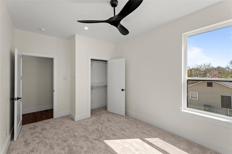 Unfurnished bedroom with light carpet, a closet, a ceiling fan, and recessed lighting