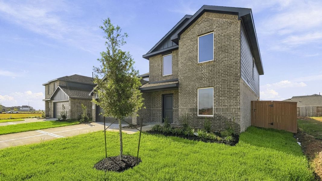 Front exterior of a new home in Sunterra, Katy, TX, highlighting curb appeal (Image 14). Front exterior of a new home in Sunterra, Katy, TX, highlighting curb appeal (Image 14).