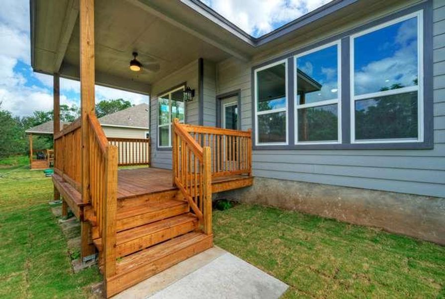 A spacious timber deck extends from the residence, providing a welcoming outdoor living area.
