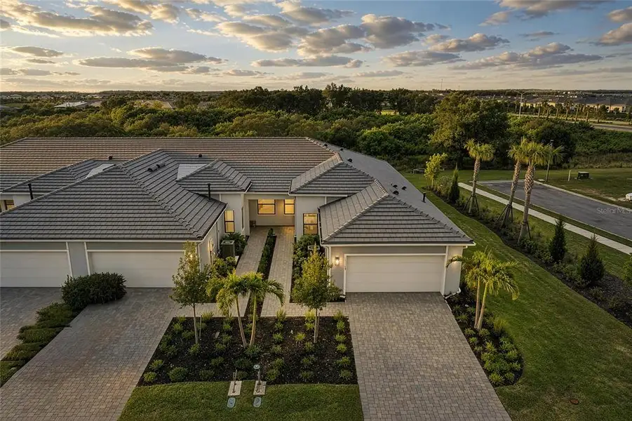 Front exterior of a new home in , Lakewood Ranch, FL, highlighting curb appeal (Image 25). Front exterior of a new home in , Lakewood Ranch, FL, highlighting curb appeal (Image 25).