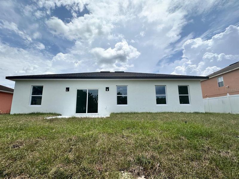 Front exterior of a new home in , Poinciana, FL, highlighting curb appeal (Image 21). Front exterior of a new home in , Poinciana, FL, highlighting curb appeal (Image 21).