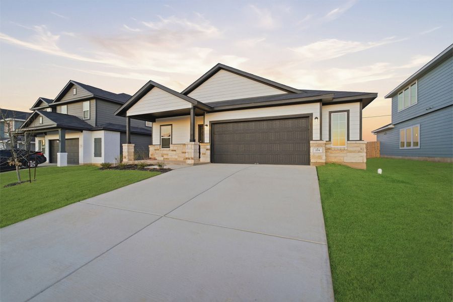 Front exterior of a new home in Hunters Glen, Jarrell, TX, highlighting curb appeal (Image 2). Front exterior of a new home in Hunters Glen, Jarrell, TX, highlighting curb appeal (Image 2).