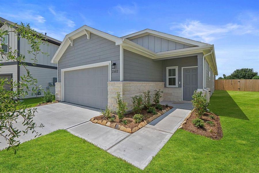 Front exterior of a new home in Peppervine, Porter, TX, highlighting curb appeal (Image 14). Front exterior of a new home in Peppervine, Porter, TX, highlighting curb appeal (Image 14).