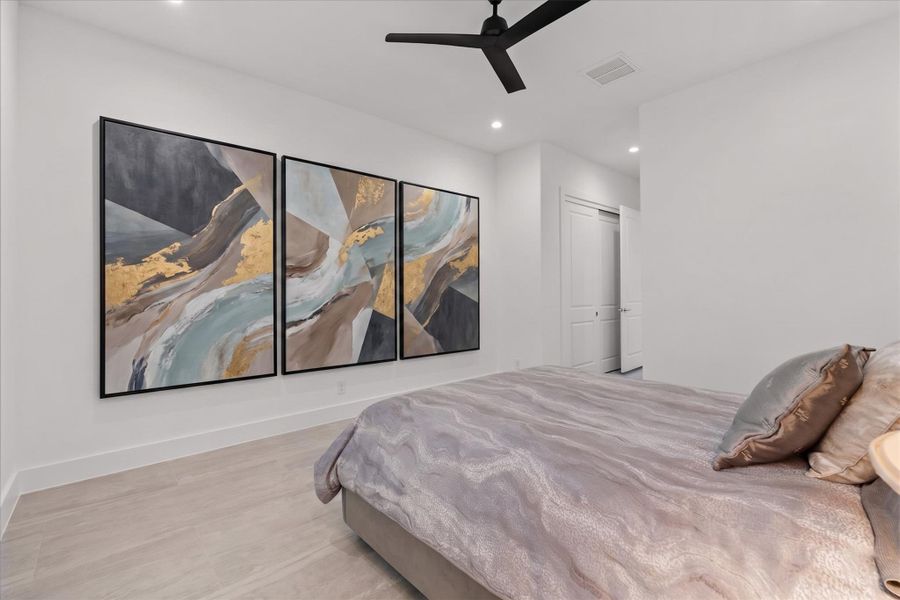 One of several well-appointed bedrooms offering a quiet retreat with a neutral palette.