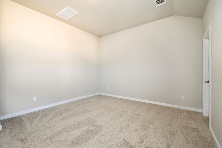 Escape and relax in the exquisite primary suite, a haven to unwind after a long day. Thespacious room, located on first floor, boasts plush carpeting, soothing paint tones, highceilings, and expansive windows adorned with privacy blinds. Sample photo of completed home with similar floor plan. Actual colors and selections may vary.