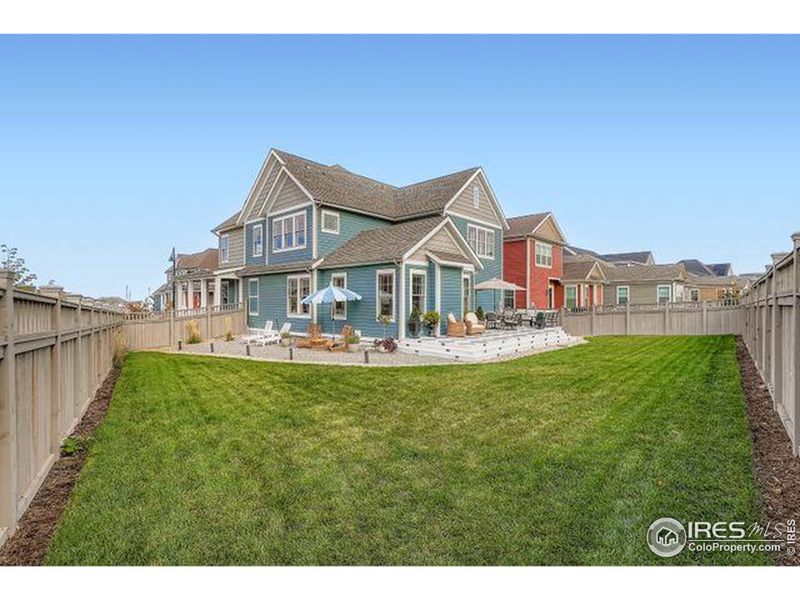 Expansive back yard with plenty of relaxation zones. Porcelain patio has lighted stairs Expansive back yard with plenty of relaxation zones. Porcelain patio has lighted stairs