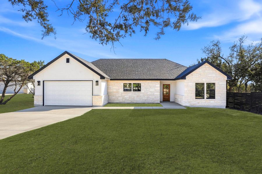 White stone and siding provide a striking facade for this charming home with an attached garage. White stone and siding provide a striking facade for this charming home with an attached garage.