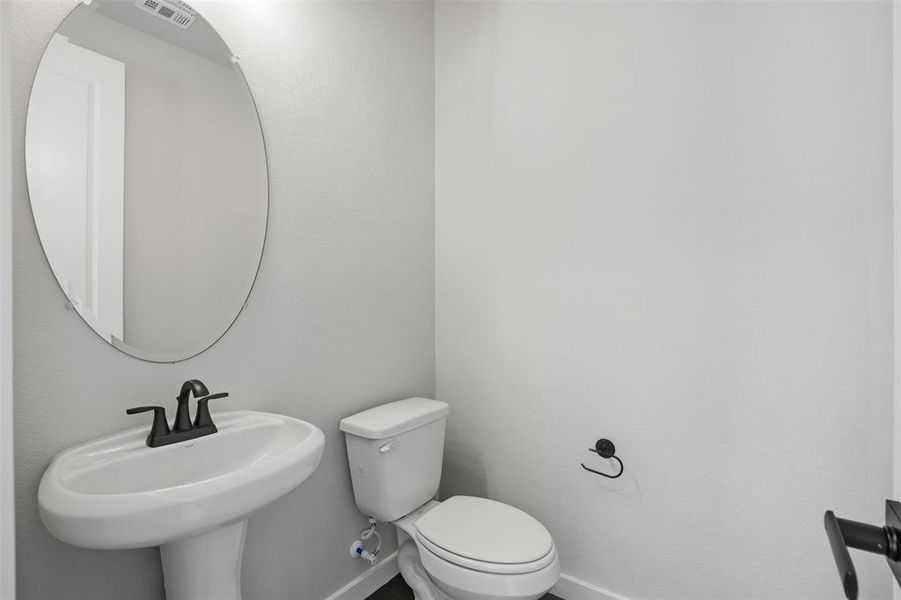 Half bath with toilet and baseboards Half bath with toilet and baseboards