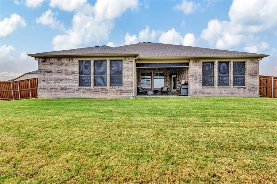 Back of house featuring solar screen on the windows.