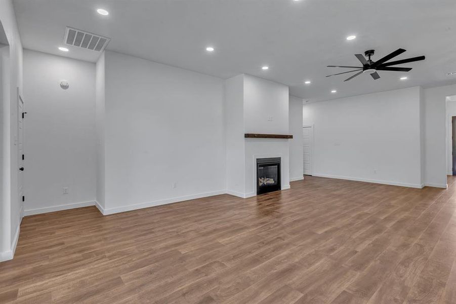 Unfurnished living room featuring light hardwood / wood-style floors and ceiling fan