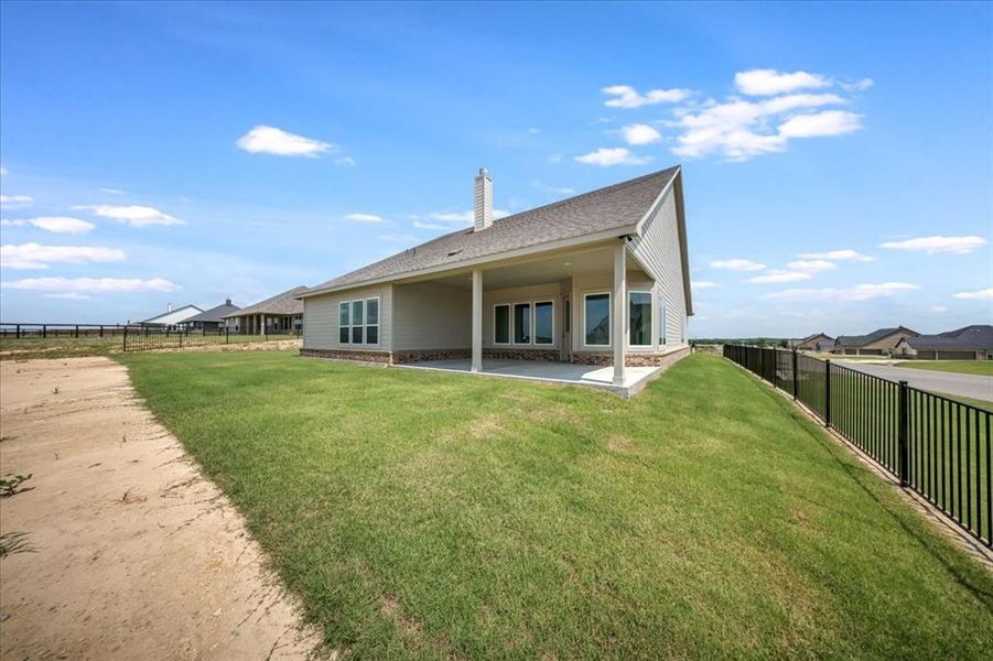 Rear view of house with a fenced backyard, a patio, roof with shingles, and a chimney Rear view of house with a fenced backyard, a patio, roof with shingles, and a chimney