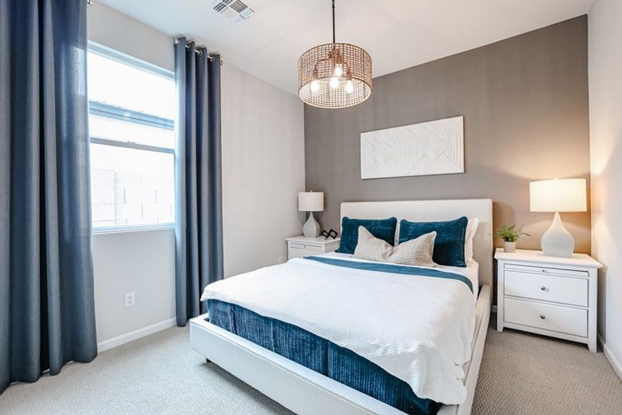 A bedroom with a bed and lamps. A bedroom with a bed and lamps.