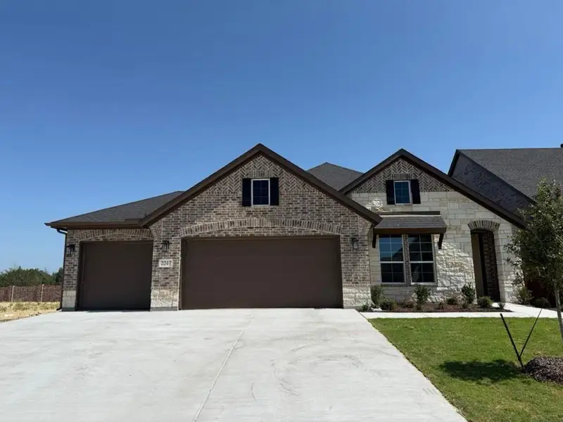 Front exterior of a new home in Waterford Park, Weatherford, TX, highlighting curb appeal (Image 2). Front exterior of a new home in Waterford Park, Weatherford, TX, highlighting curb appeal (Image 2).