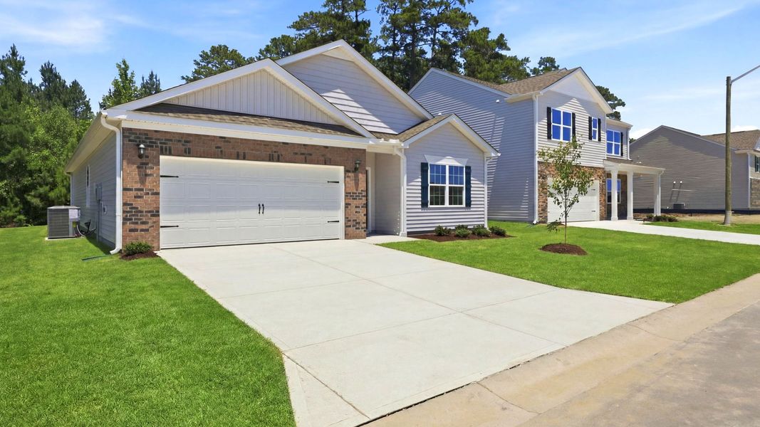 Front exterior of a new home in Ridgewood Farms, Winterville, NC, highlighting curb appeal (Image 2). Front exterior of a new home in Ridgewood Farms, Winterville, NC, highlighting curb appeal (Image 2).