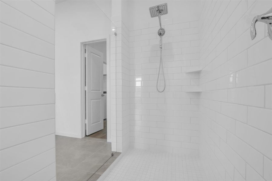 Primary Shower: Oversized walk-in design with full tile surround, built-in shelving, and a spa-inspired rain shower that elevates the primary suite experience. Primary Shower: Oversized walk-in design with full tile surround, built-in shelving, and a spa-inspired rain shower that elevates the primary suite experience.