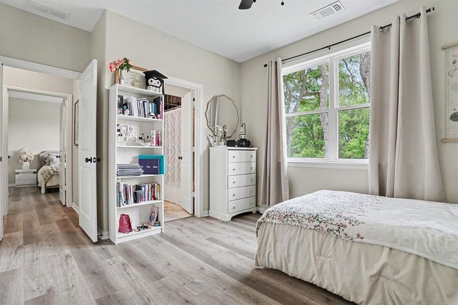 1st Floor Bedroom featuring light wood finished floors, a ceiling fan and office nook