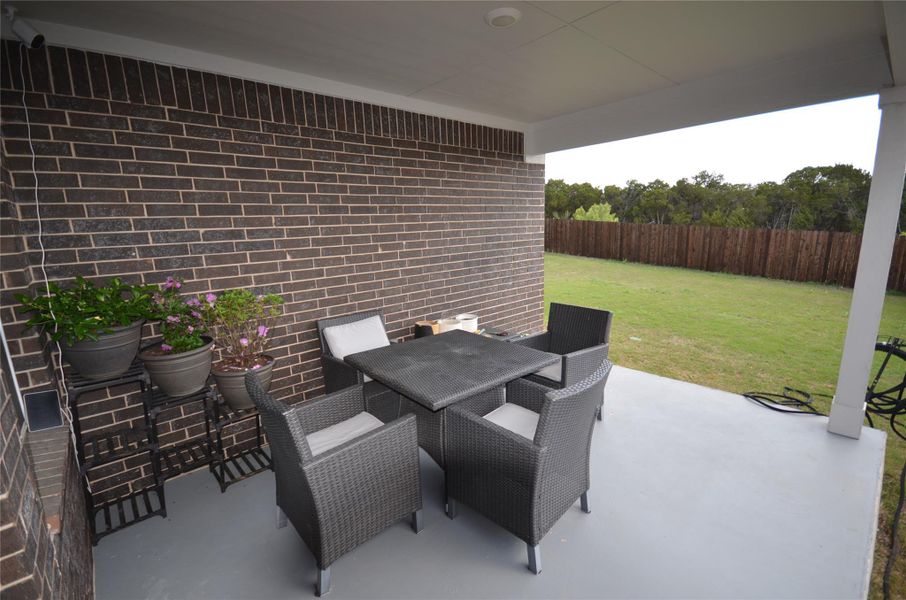 Fenced backyard featuring outdoor dining space and a patio Fenced backyard featuring outdoor dining space and a patio