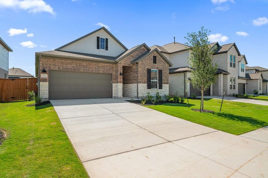 Front exterior of a new home in Arbor Collection at Lariat, Liberty Hill, TX, highlighting curb appeal (Image 18). Front exterior of a new home in Arbor Collection at Lariat, Liberty Hill, TX, highlighting curb appeal (Image 18).