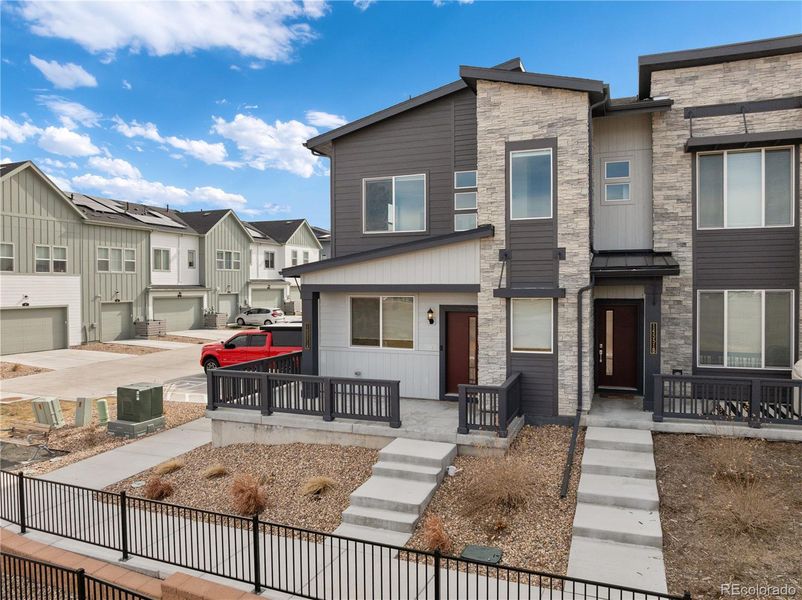 Front exterior of a new home in Whisper Village, Arvada, CO, highlighting curb appeal (Image 2).