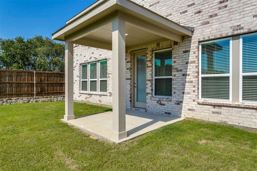 Exterior details and patio area of a home in The Preserve, Justin (Image 19).
