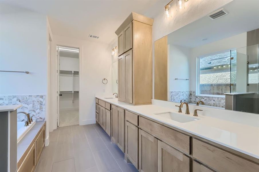 Bathroom with vanity, tile patterned floors, and separate shower and tub