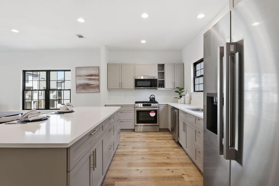 (Photos are from the Model Home - and for representation only)  Gas stove and oven with exterior vent hood, offering efficient cooking and proper ventilation.