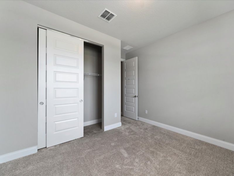 Bedroom in the Coral floorplan at 6295 NW Sweetwood Drive in Brystol at Wylder