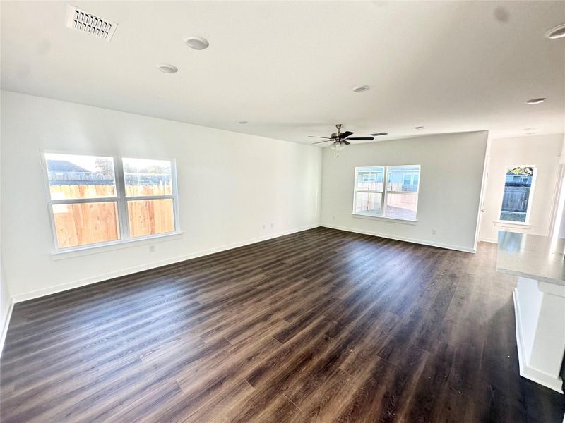 Unfurnished room featuring dark wood-style floors and baseboards