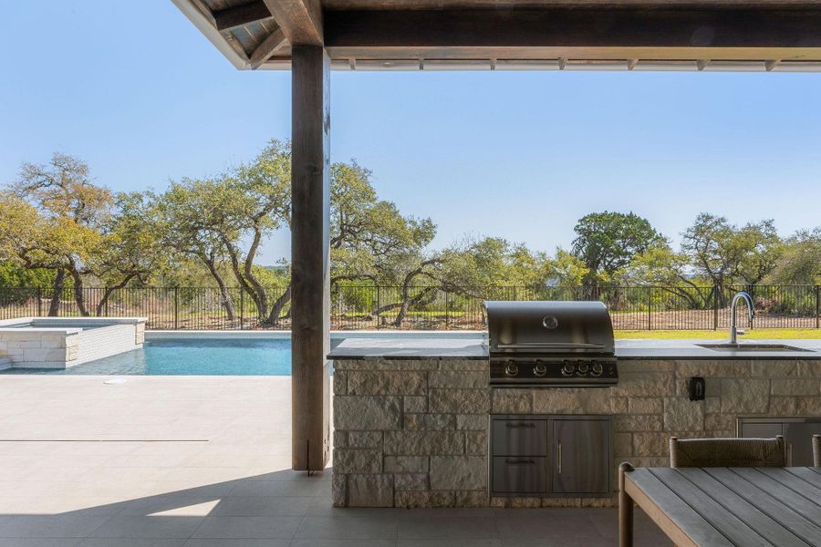 Gas grill outside overlooking the trees and pool!