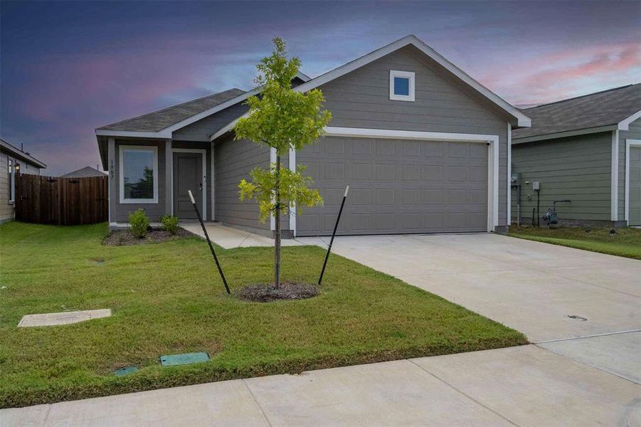 Ranch-style house featuring concrete driveway and an attached garage Ranch-style house featuring concrete driveway and an attached garage