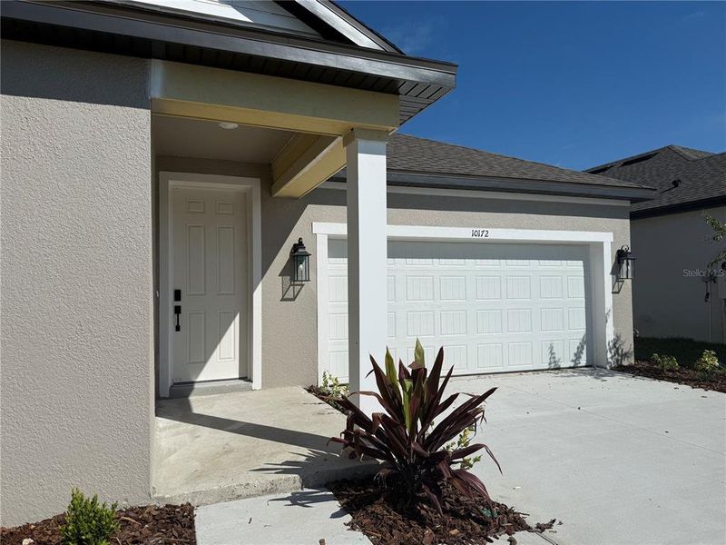 Exterior details and patio area of a home in Oakfield Trails Traditional, Parrish (Image 2).
