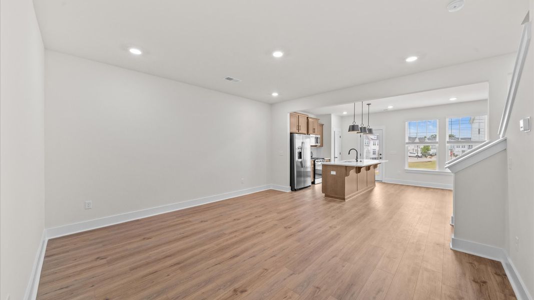 Elegant family room with hardwood flooring and open-concept flow in this first-class DRB Homes design Elegant family room with hardwood flooring and open-concept flow in this first-class DRB Homes design