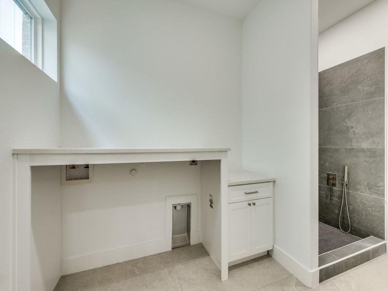 Laundry room featuring hookup for a washing machine and light tile patterned floors