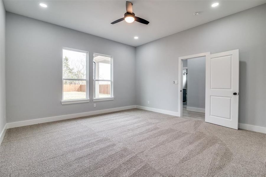 Spare room featuring carpet flooring and ceiling fan