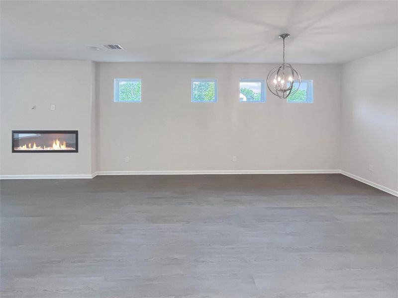 The Robin II- Family Room with Linear Electric Fireplace into the Dining. Sample image to be used for example only.