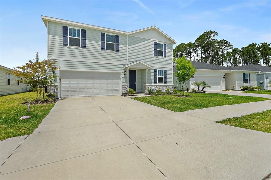 Front exterior of a new home in , Palm Coast, FL, highlighting curb appeal (Image 26). Front exterior of a new home in , Palm Coast, FL, highlighting curb appeal (Image 26).