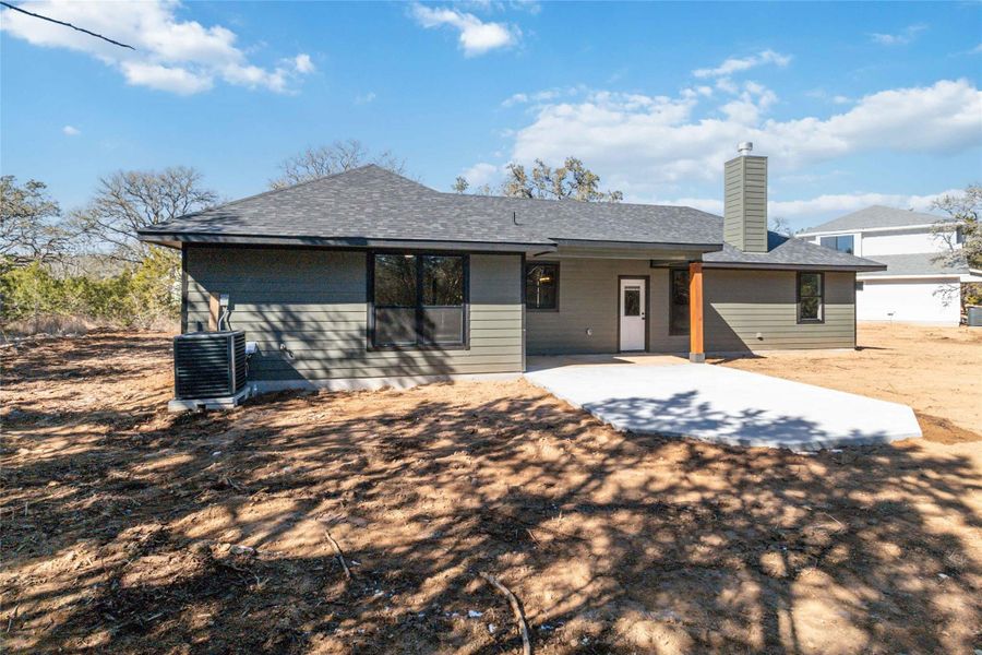 Back of house with an extended patio and covered patio