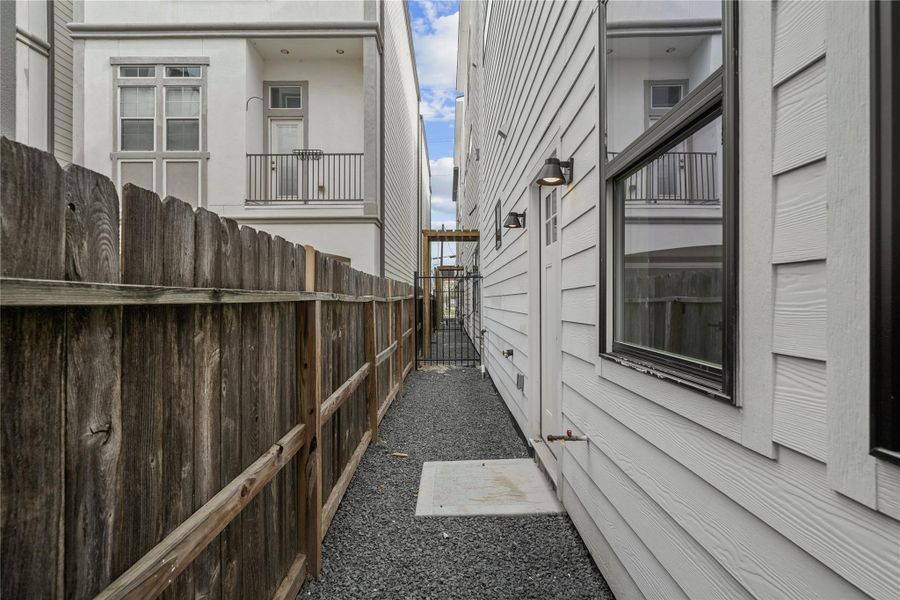 The backyard features a wrought iron fence and space for your pet or garden.