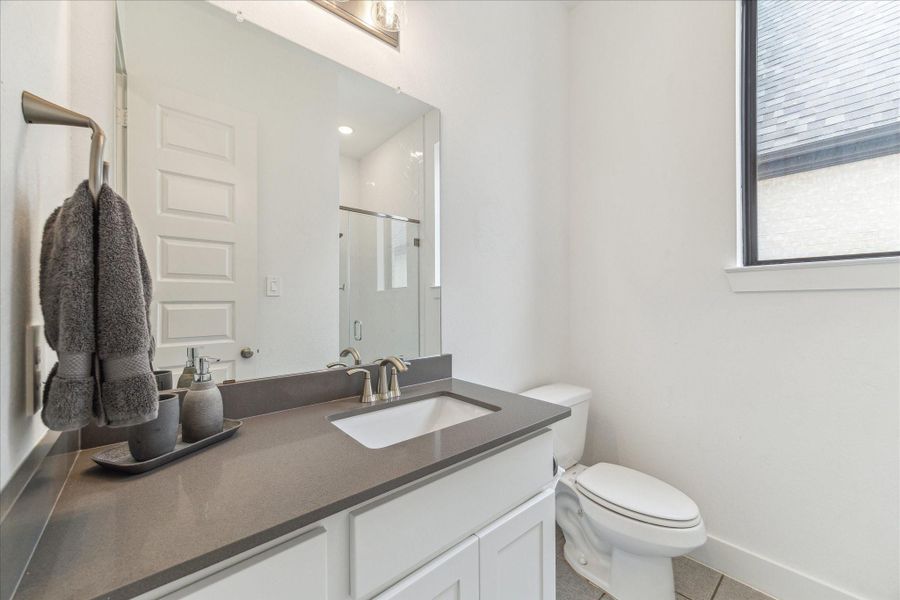 Bathroom is neutral with gray countertop and white vanity. Bathroom is neutral with gray countertop and white vanity.