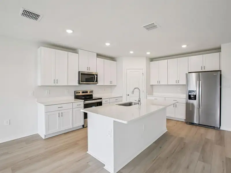 Furnished interior view inside a new home in The Grove at Stuart Crossing - Classic Series, Bartow (Image 6).