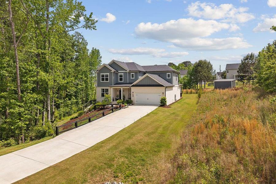 Front exterior of a new home in The Estate at Old Friendship, Buford, GA, highlighting curb appeal (Image 2). Front exterior of a new home in The Estate at Old Friendship, Buford, GA, highlighting curb appeal (Image 2).