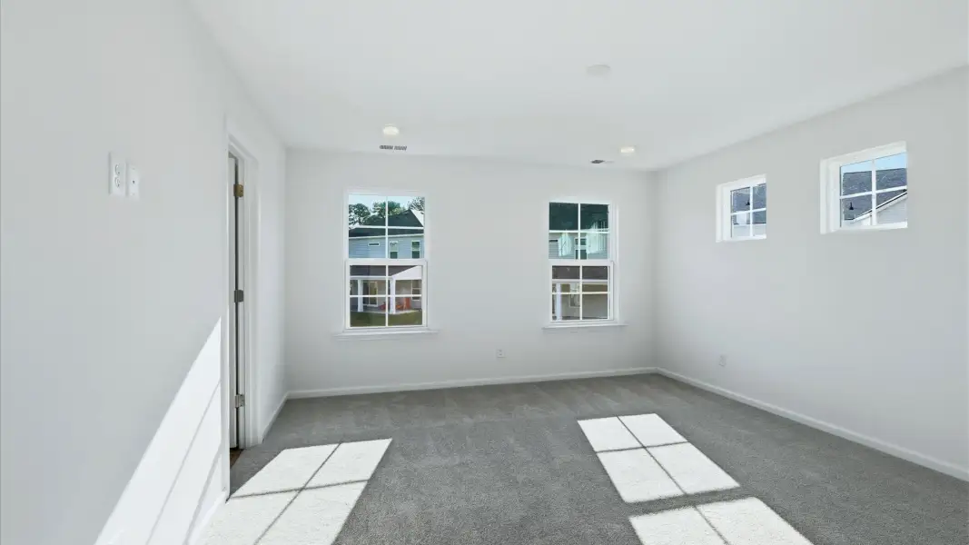 Relax in the bright and airy primary suite of the Pritchard