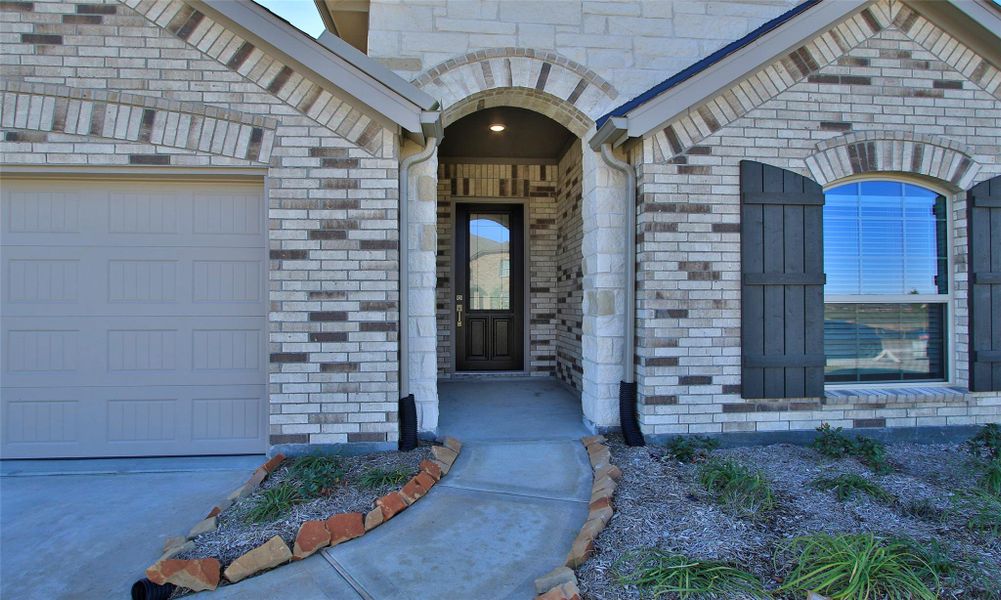 Exterior details and patio area of a home in Sunterra, Katy (Image 19).